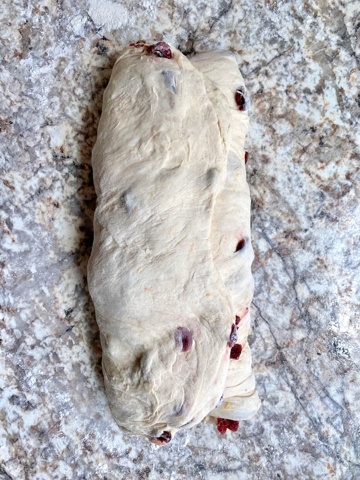 The cranberry orange sourdough bread dough folded into thirds like a letter.