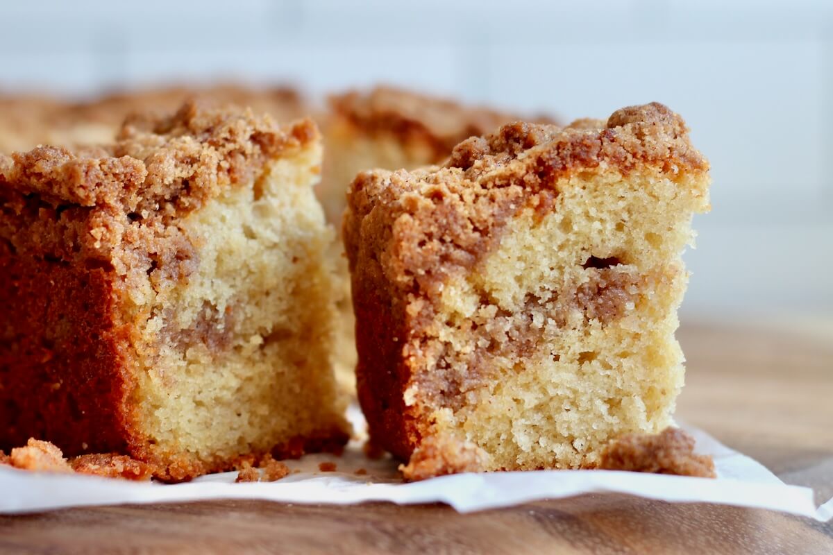 Sourdough discard coffee cake pieces on a sheet of parchment paper.