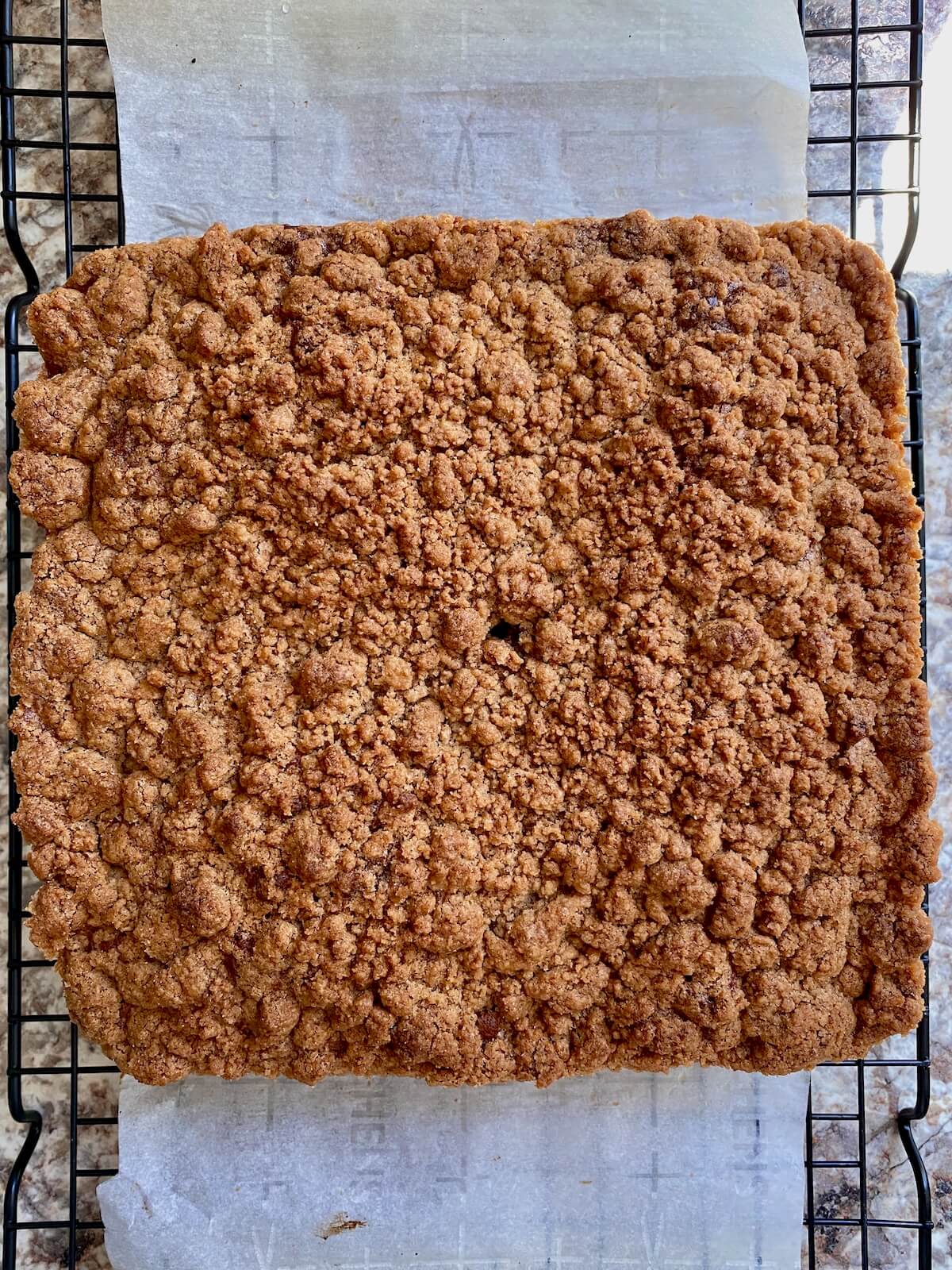 The sourdough coffee cake on a wire cooling rack after baking.