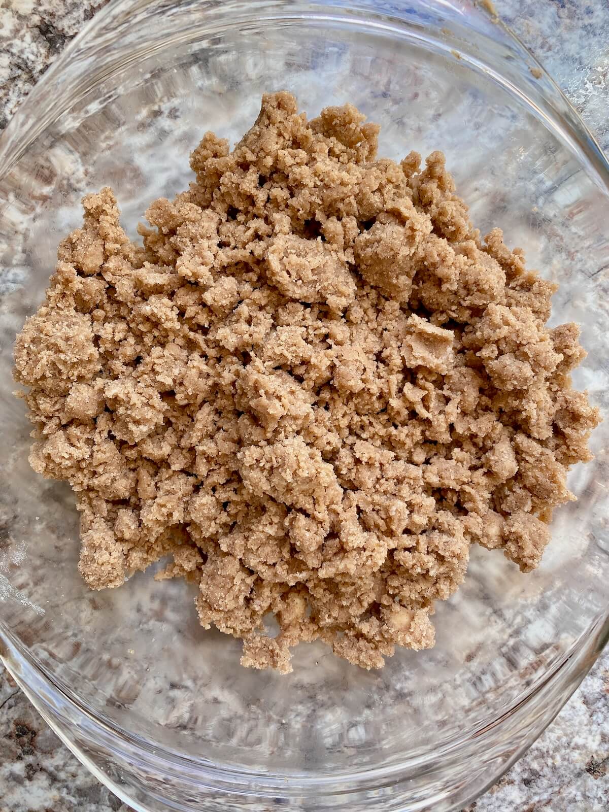 The cinnamon sugar crumble topping and filling in a glass bowl.