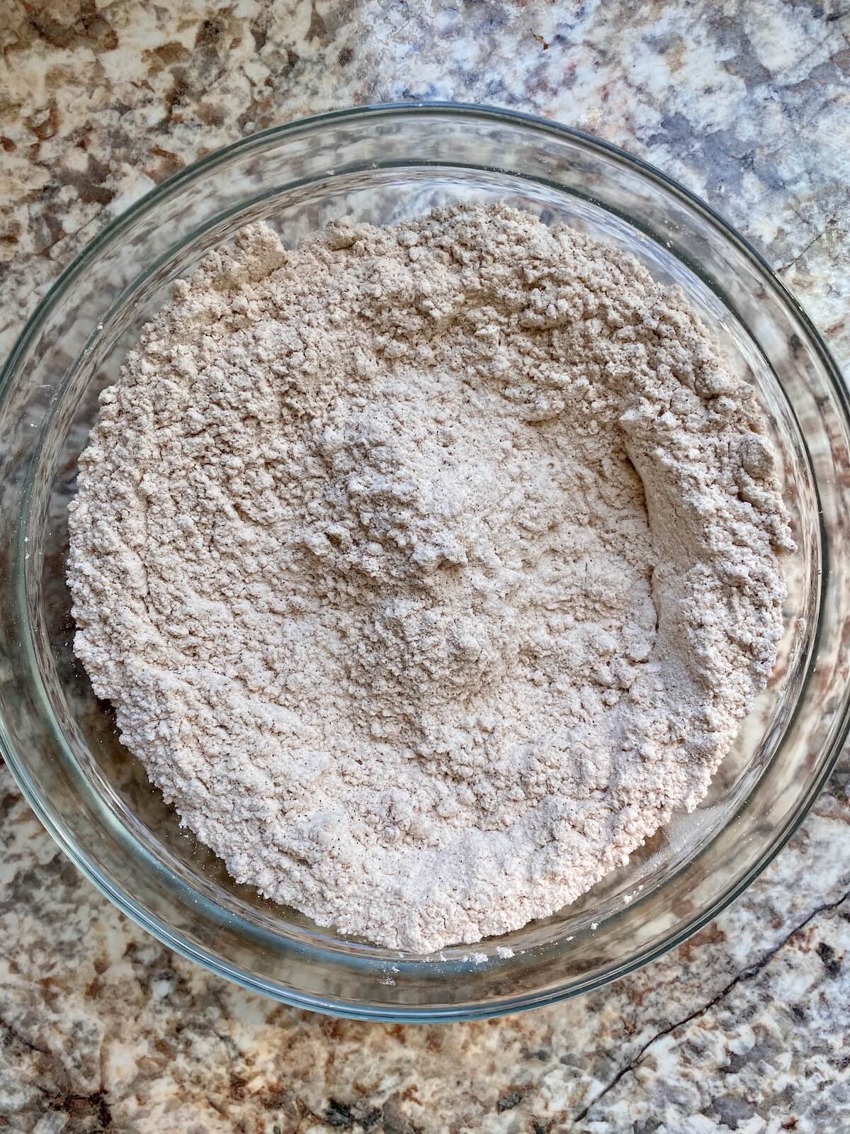 The dry ingredients mixed together in a glass bowl.