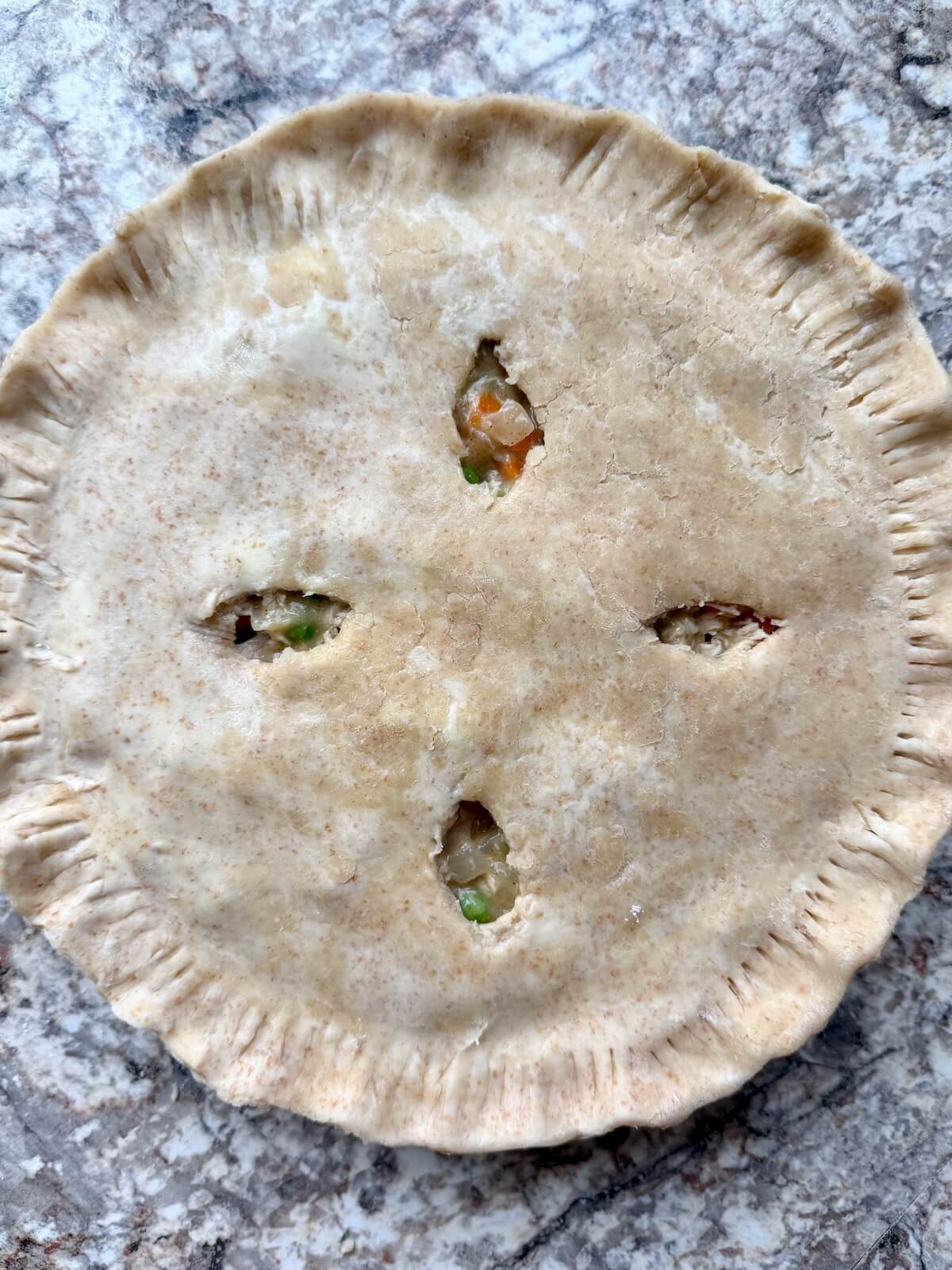 An assembled sourdough chicken pot pie before baking.