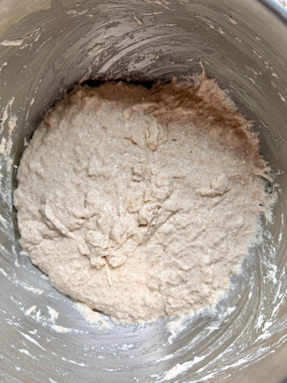Sourdough focaccia dough in a stainless steel bowl.