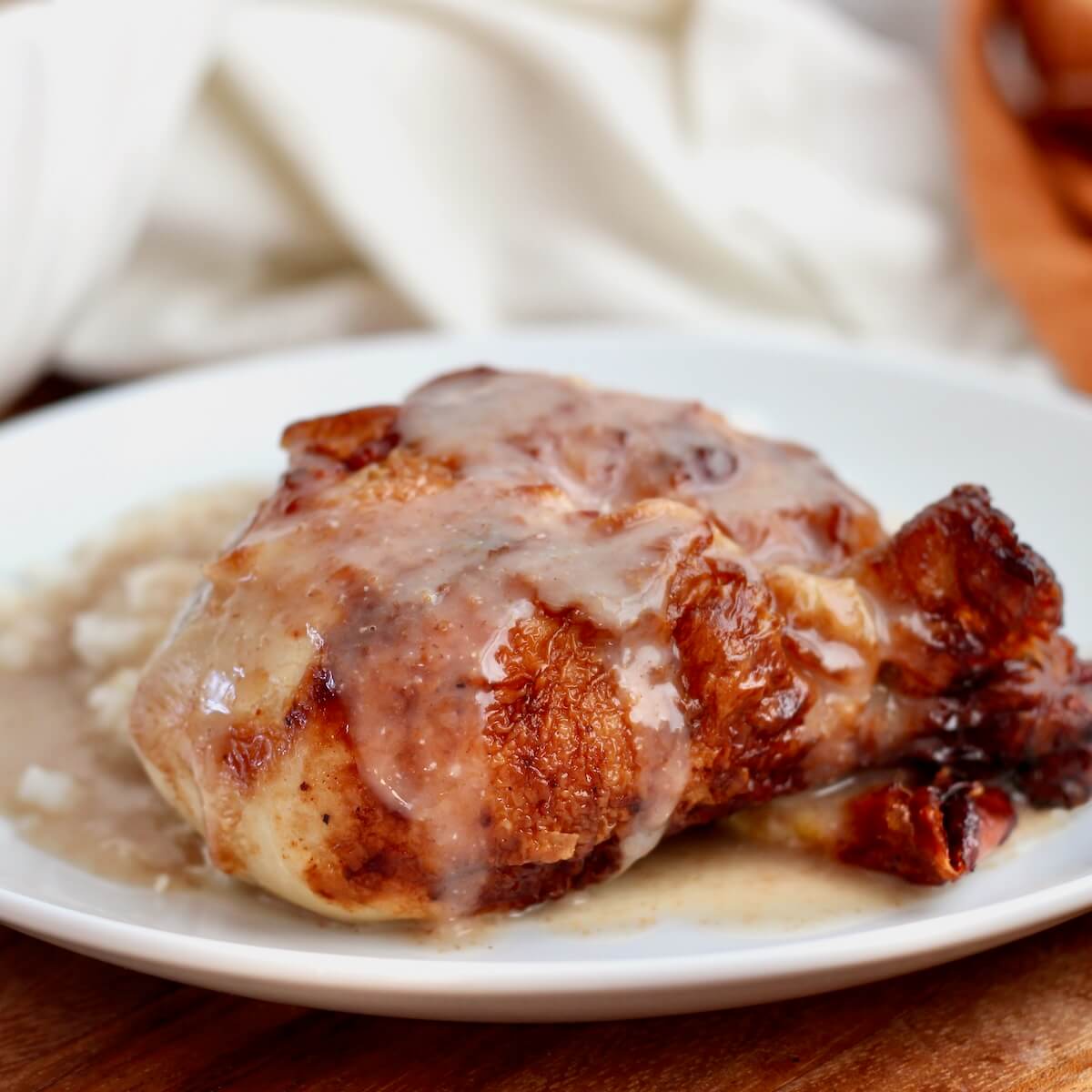 A roasted bone-in chicken thigh and potatoes smothered in sourdough gravy.
