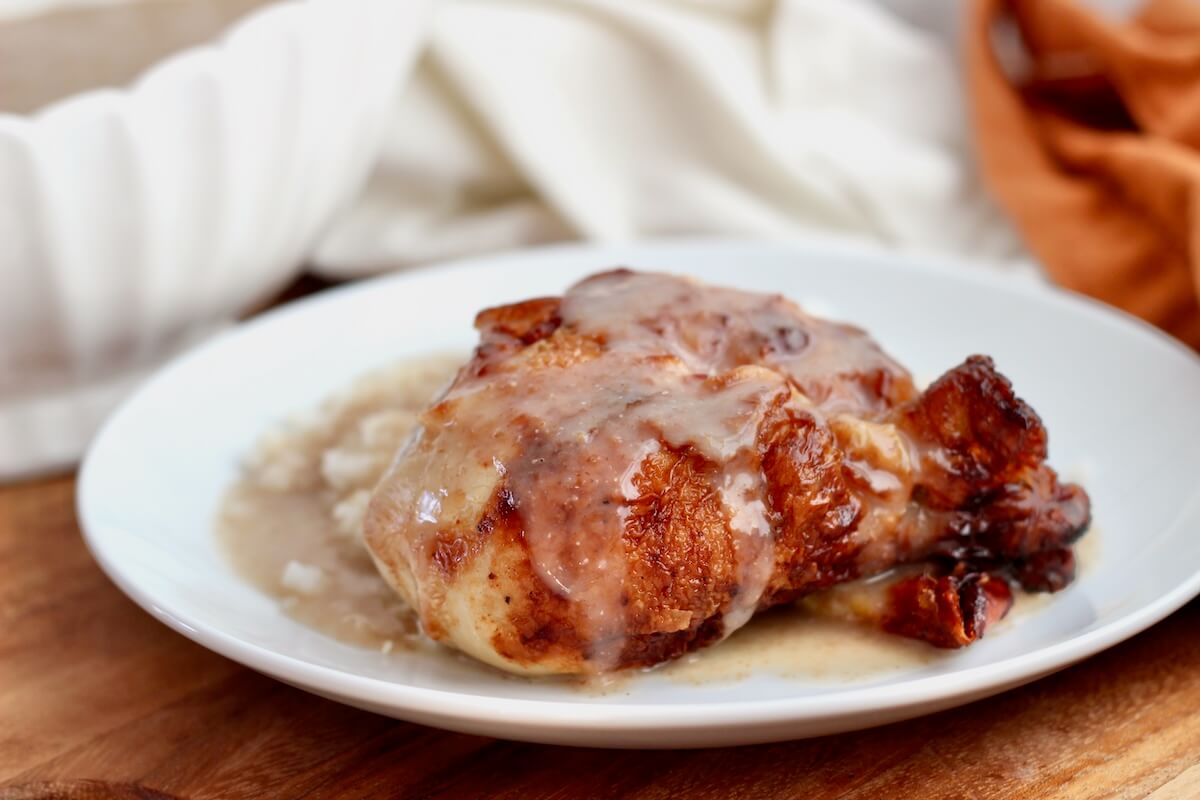 A roasted bone-in chicken thigh and potatoes smothered in sourdough gravy.