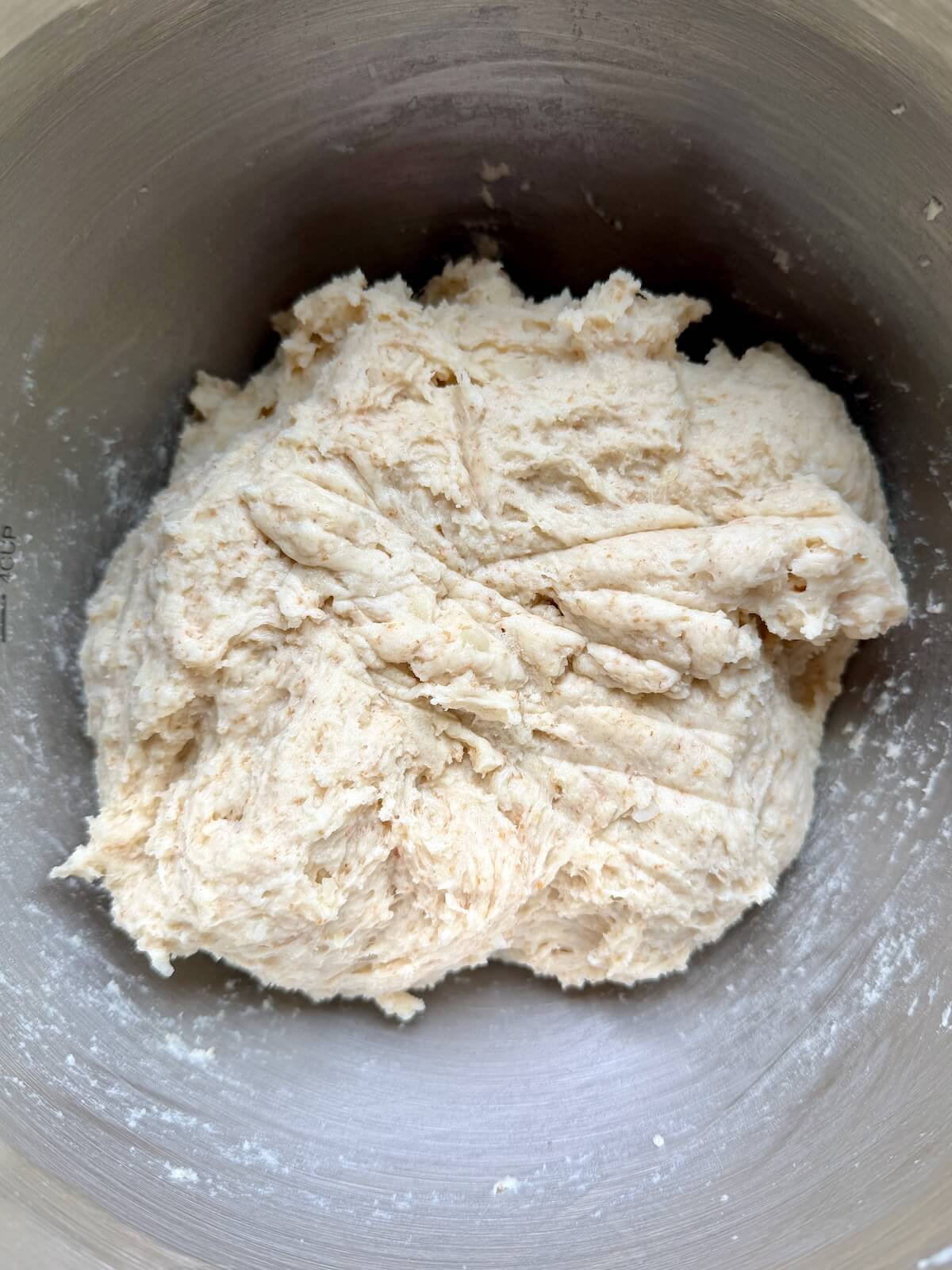 Sourdough potato bread dough in a stainless steel bowl.