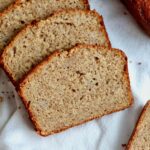 Sliced sourdough banana bread on a linen napkin.