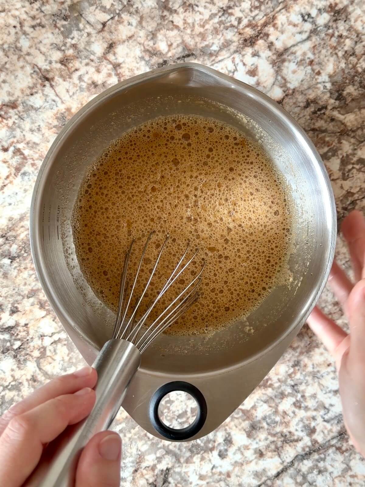 Coffee, milk, sugar, and active sourdough starter whisked together in a stainless steel bowl.