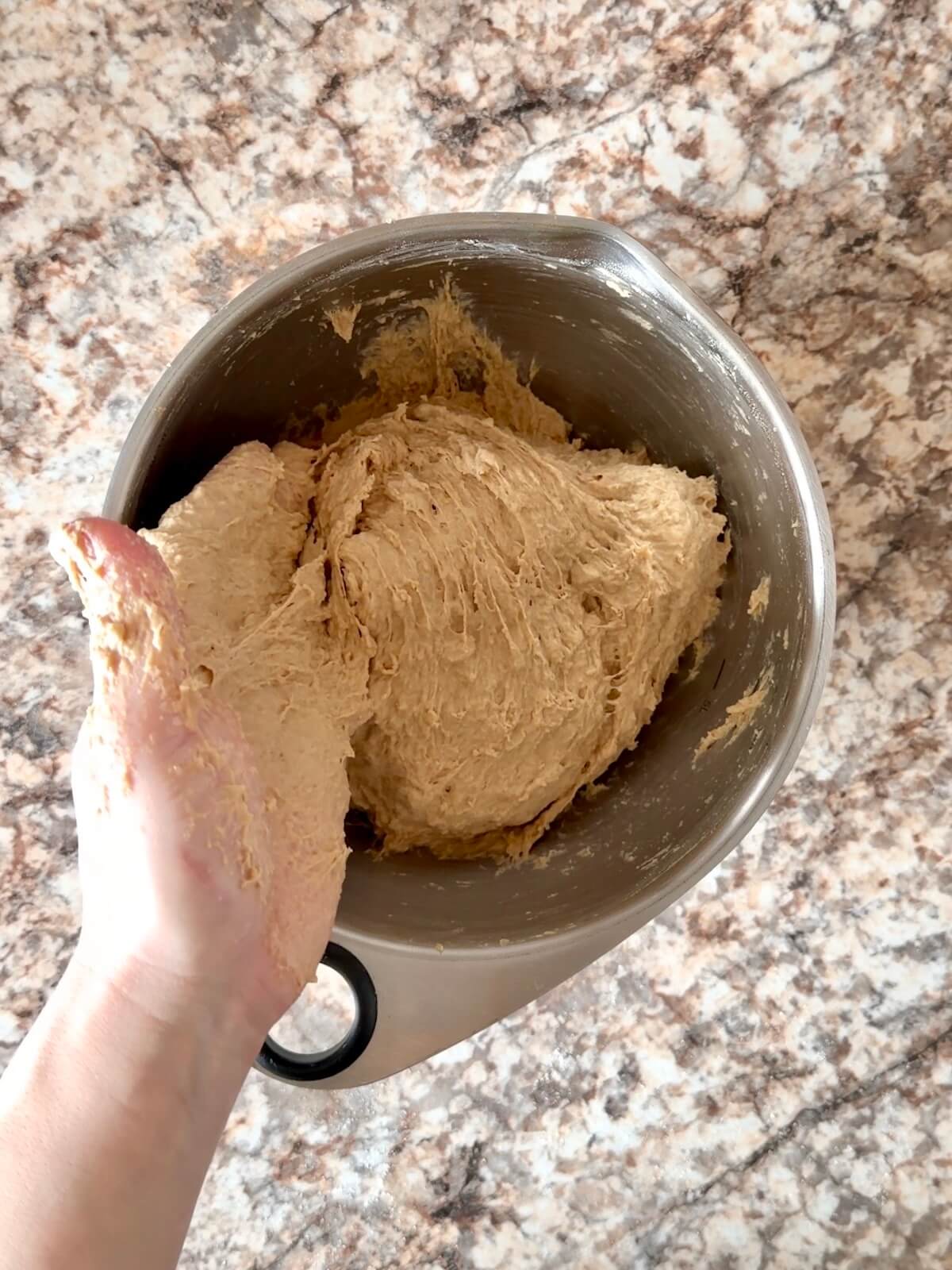 Coffee sourdough bread dough mixed in a stainless steel bowl.
