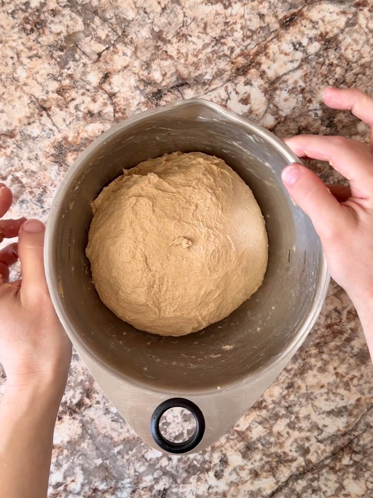 Stretched and folded coffee sourdough bread dough in a mixing bowl.
