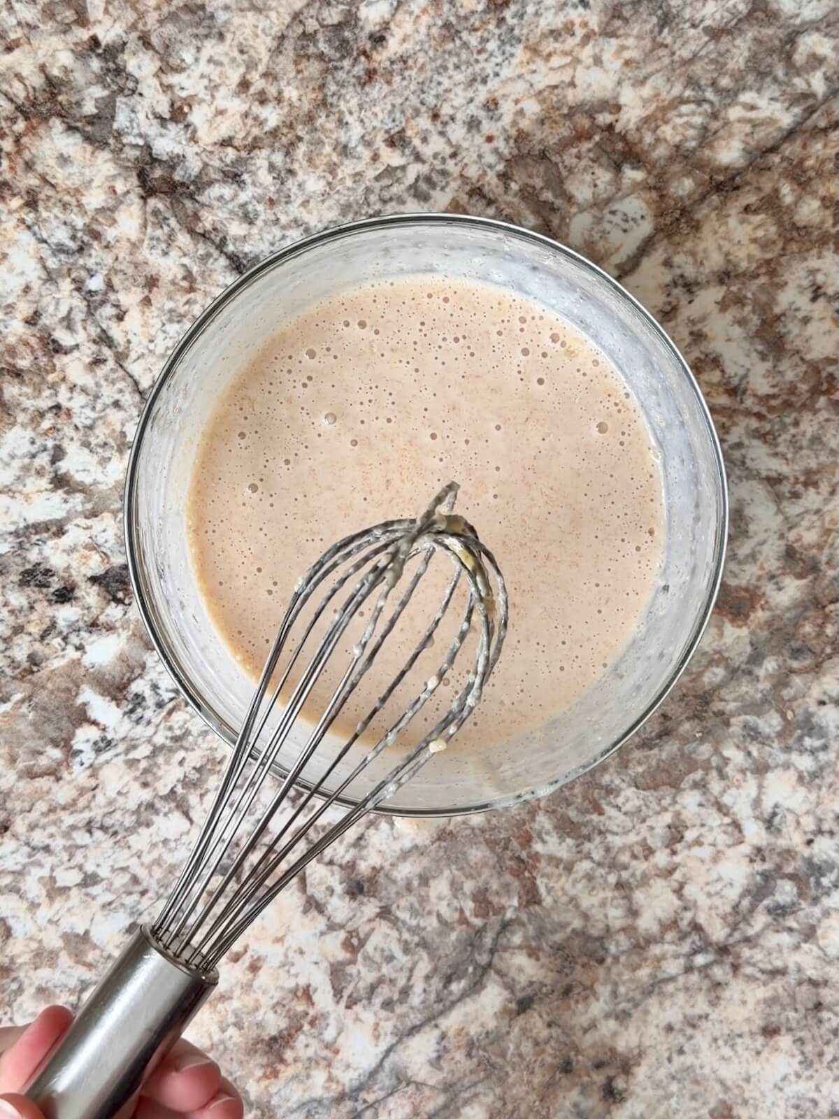 Buttermilk, sourdough discard, and melted butter whisked together in a bowl.