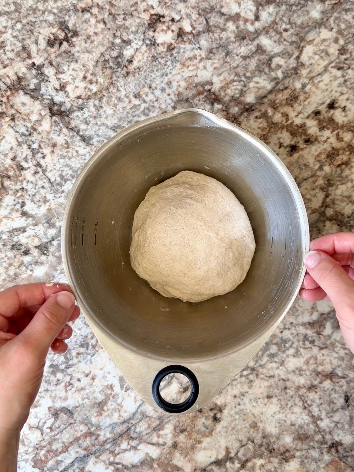 Beer sourdough pizza dough after being stretched and folded in a bowl.