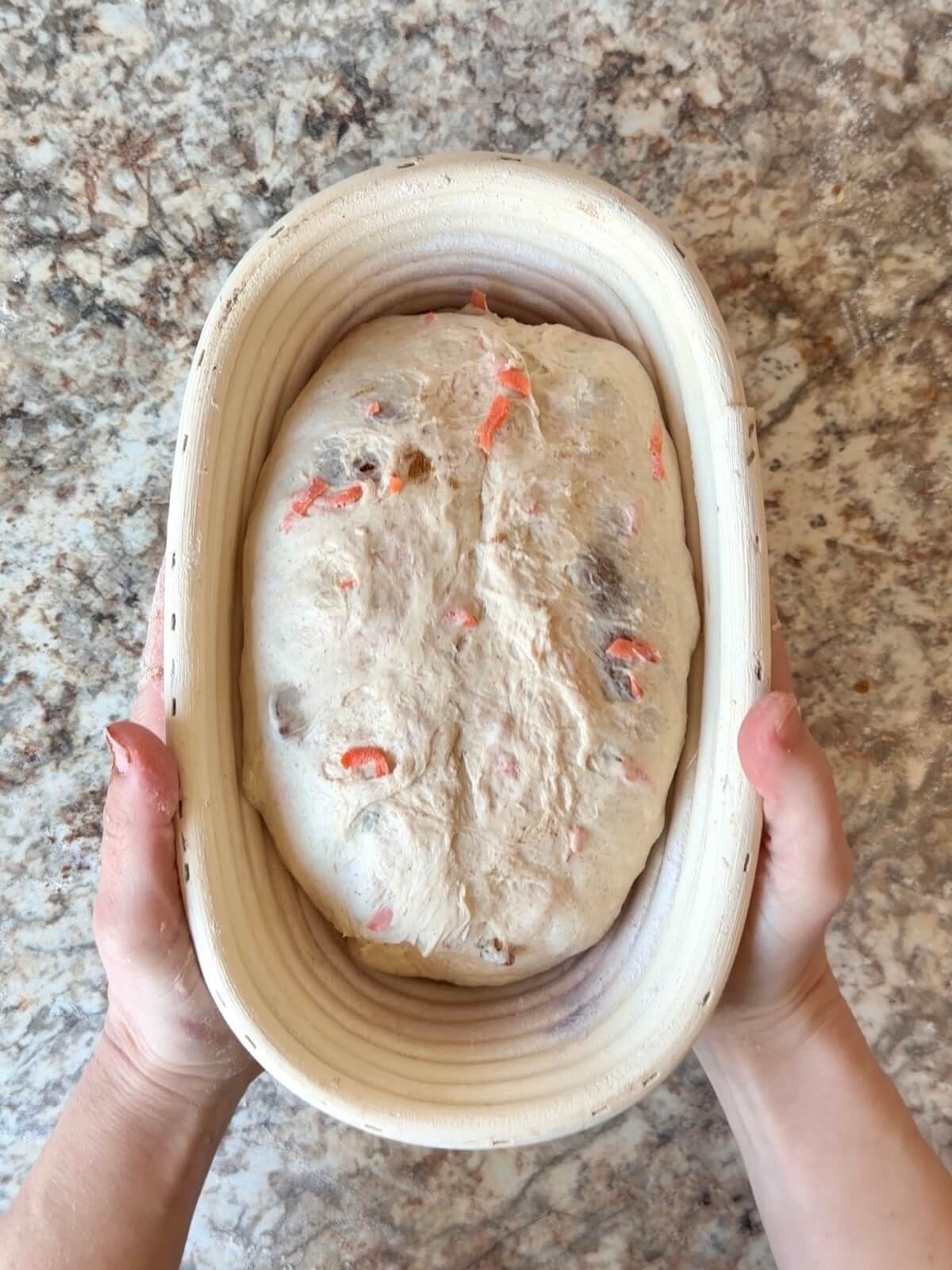 Carrot cake sourdough bread dough in an oval proofing basket before cold proofing overnight.
