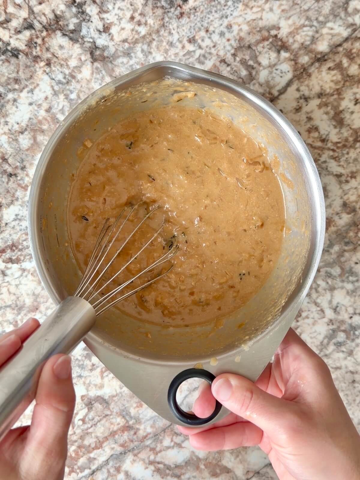 French onion soup whisked together with active sourdough starter in a bowl.