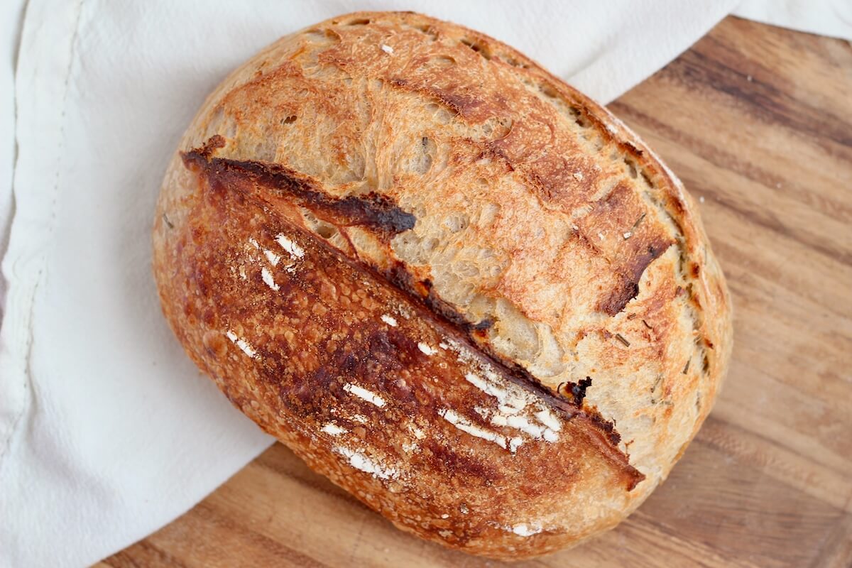 A whole loaf of rosemary parmesan sourdough bread.