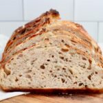A sliced loaf of rosemary parmesan sourdough bread.