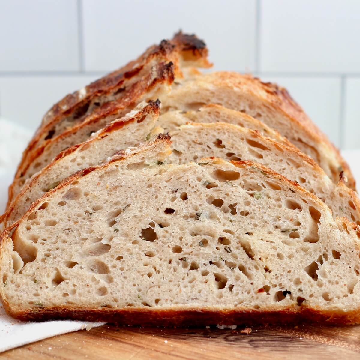 A sliced loaf of rosemary parmesan sourdough bread.