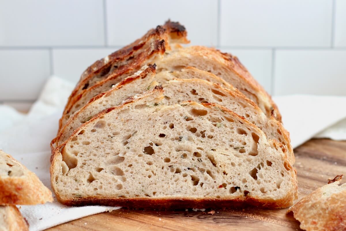 A sliced loaf of rosemary parmesan sourdough bread.