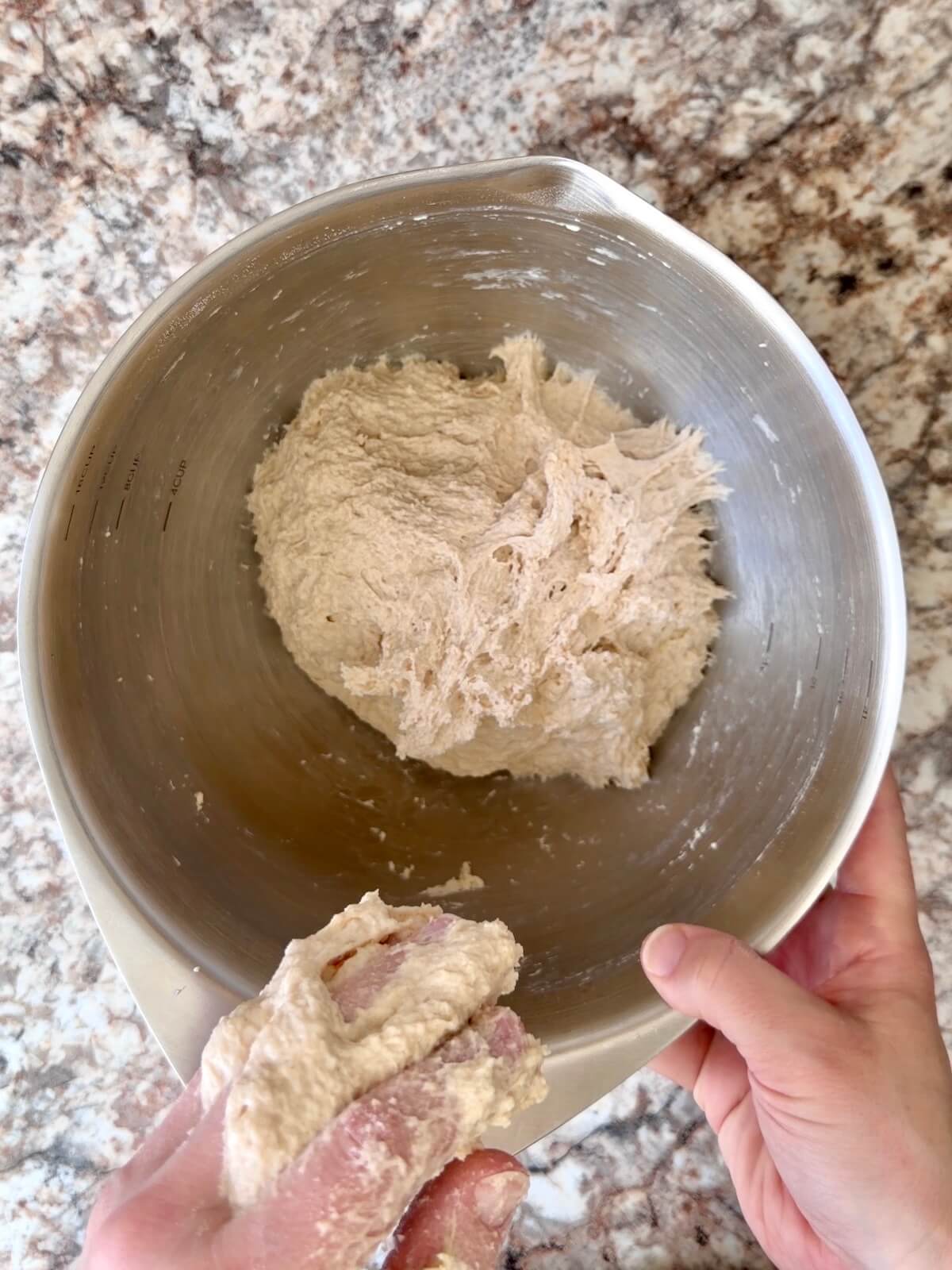 Sourdough bread dough mixed together in a bowl.