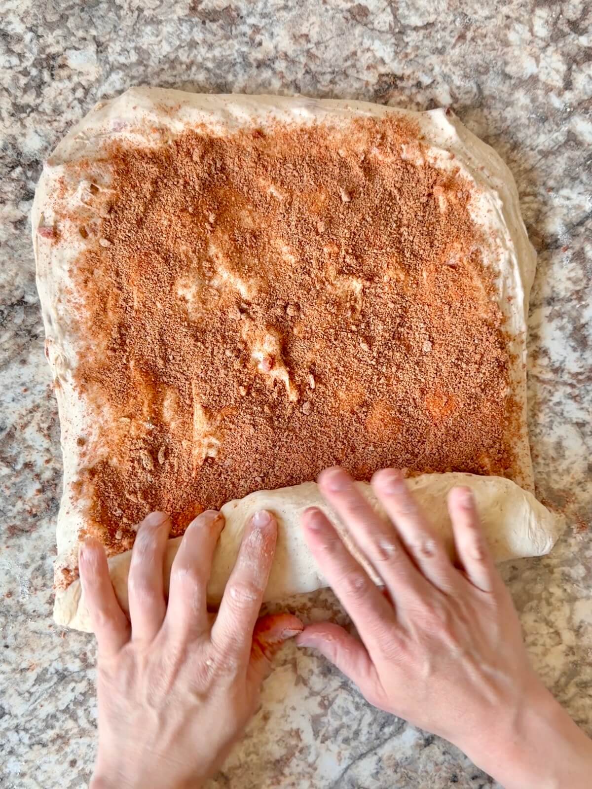 The dough being rolled up to enclose the brown sugar chipotle mixture.