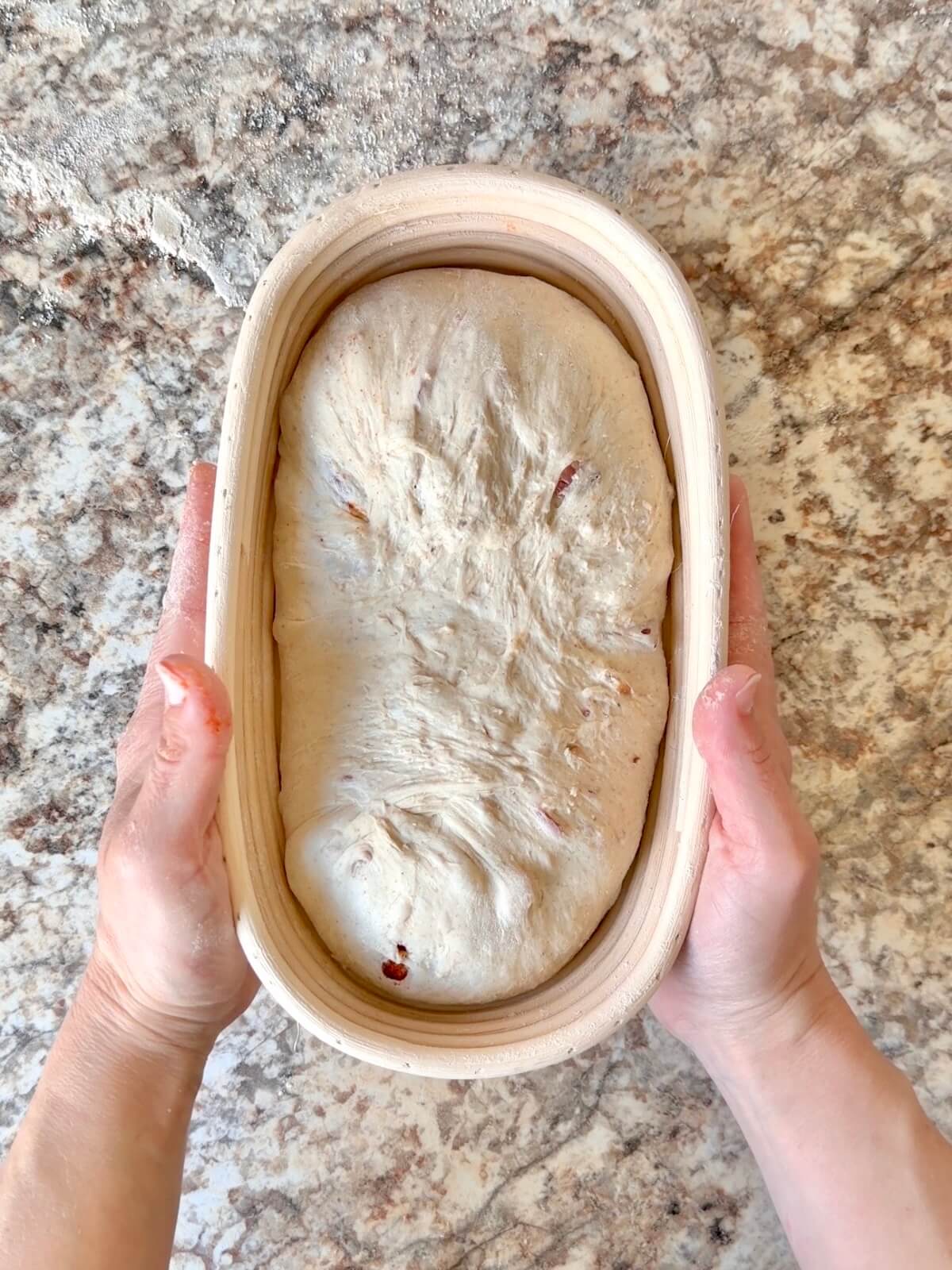 The shaped dough in an oval proofing basket before cold proofing overnight.