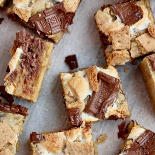 Several s'mores sourdough blondies on a piece of parchment paper.