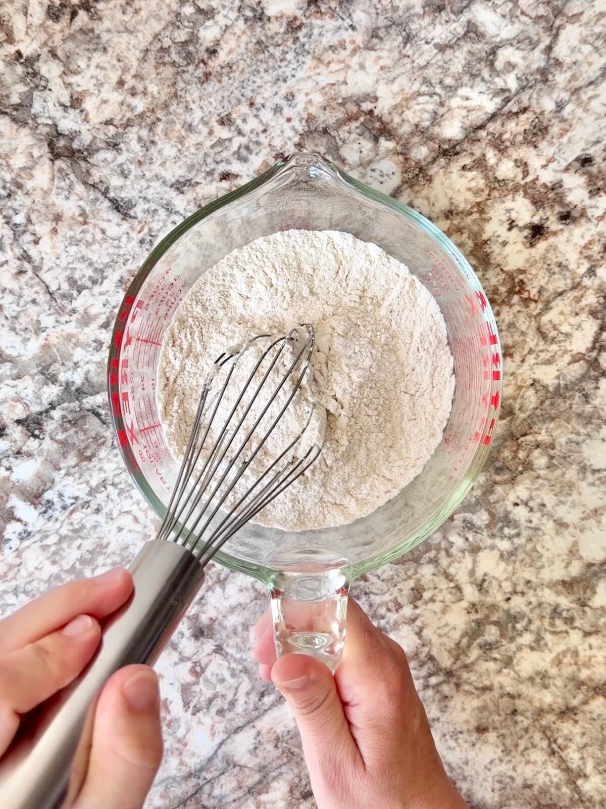 Flour, baking powder, and salt whisked together in a large glass measuring cup.