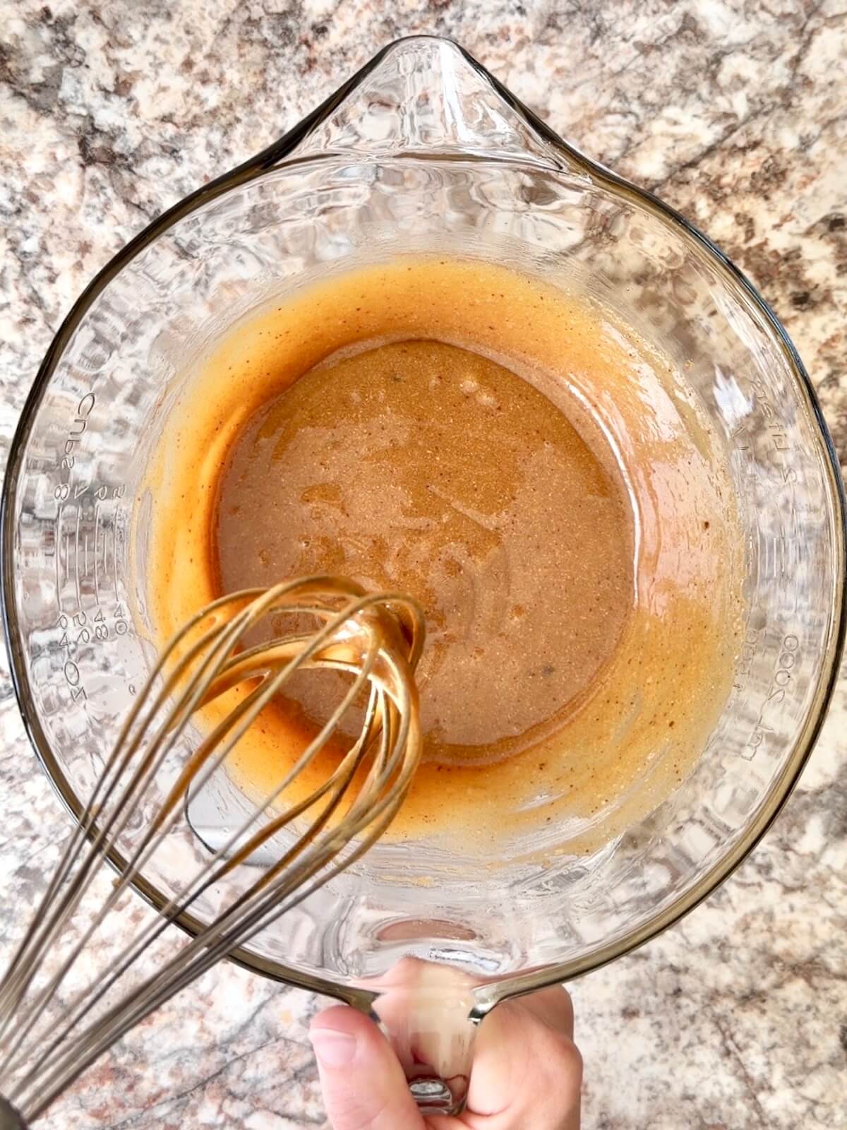 The wet ingredients mixed together in a large glass bowl.