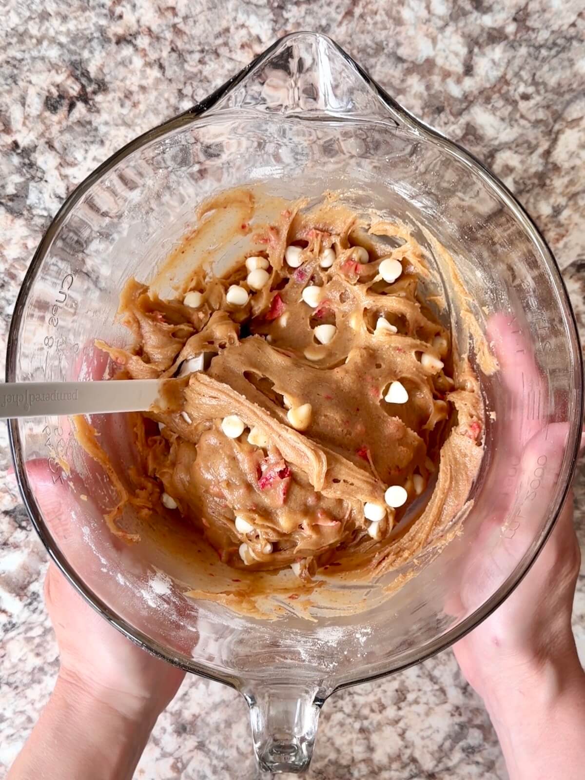 Strawberry white chocolate sourdough blondie batter in a large glass bowl.