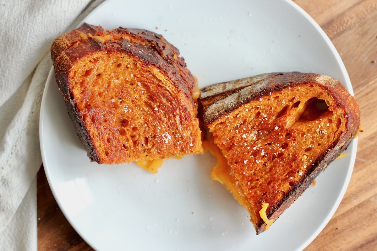 A grilled cheese sandwich made with tomato soup sourdough bread.