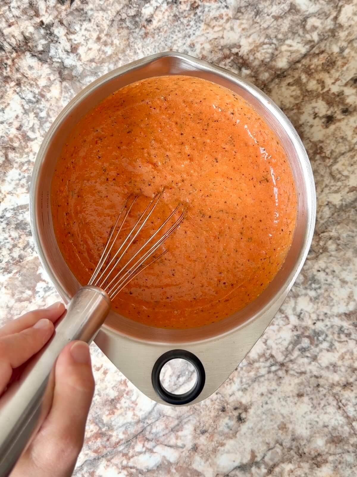 Tomato soup whisked with active sourdough starter in a bowl.