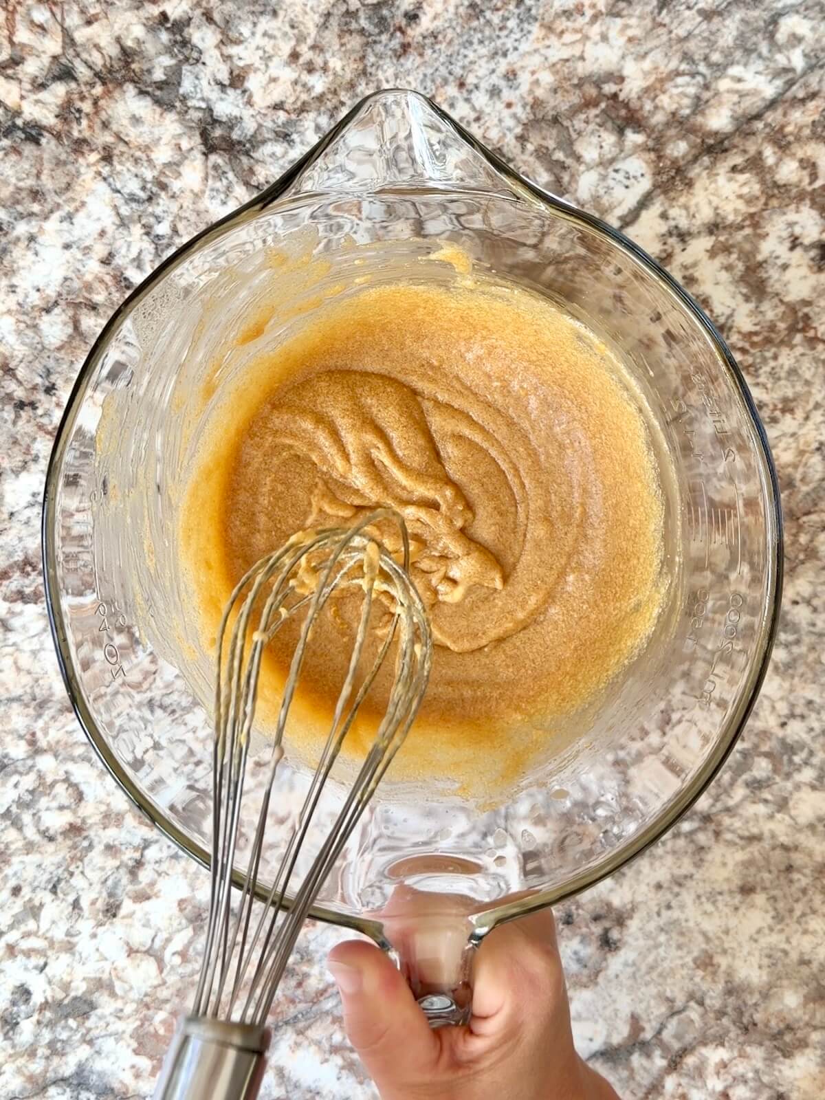 The wet ingredients being whisked together in a mixing bowl.