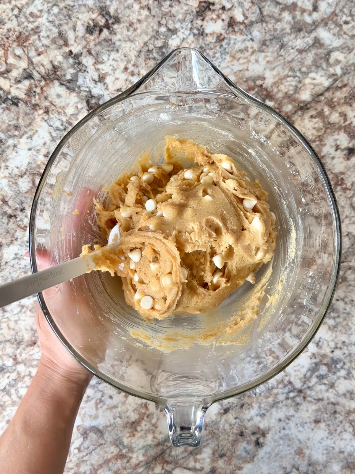 Lemon white chocolate sourdough blondie batter in a glass mixing bowl.