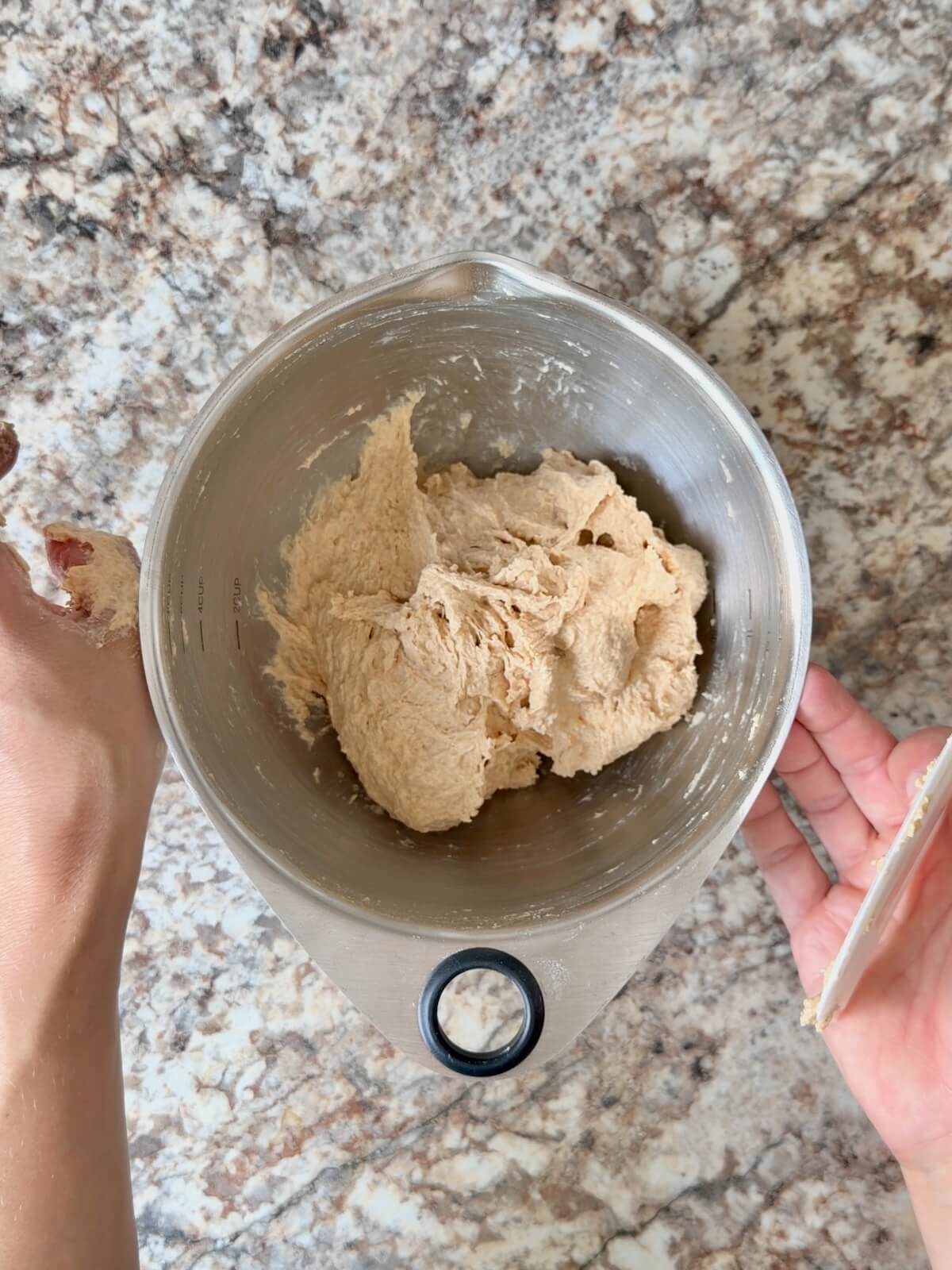 The peanut butter dough mixed in a stainless steel bowl.