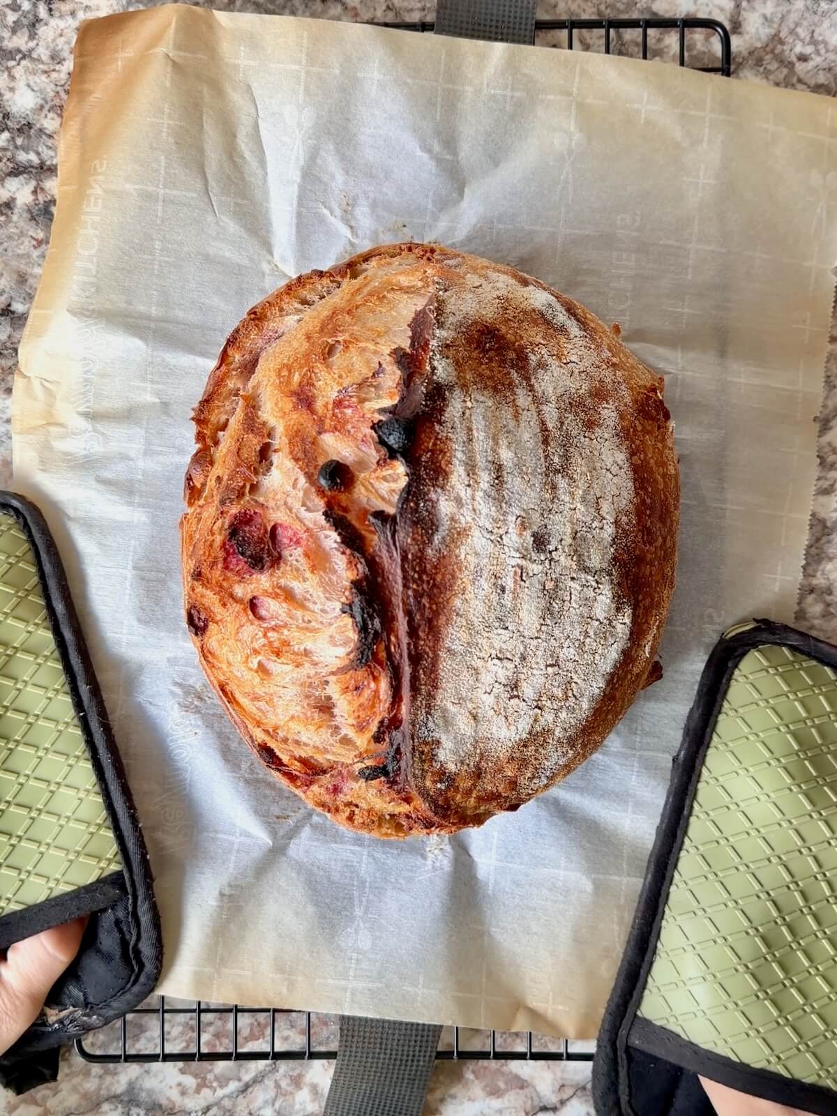 The baked peanut butter and jelly sourdough bread on a wire cooling rack.