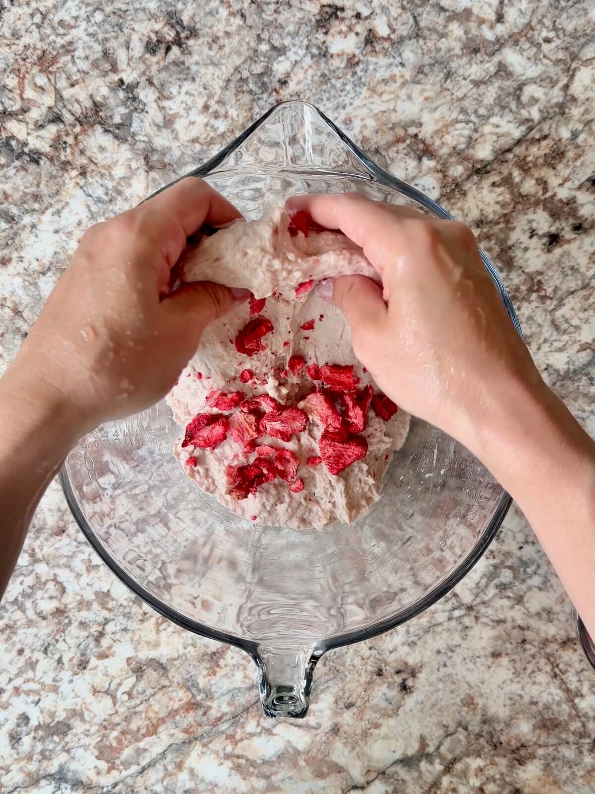 Freeze-dried strawberries being folded into the jelly dough.