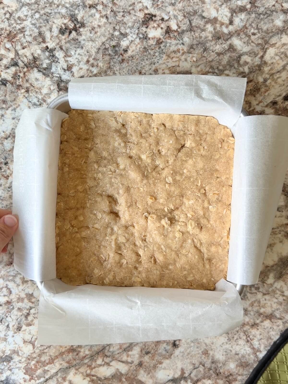 Par-baked sourdough discard oat crumble crust in a baking pan.