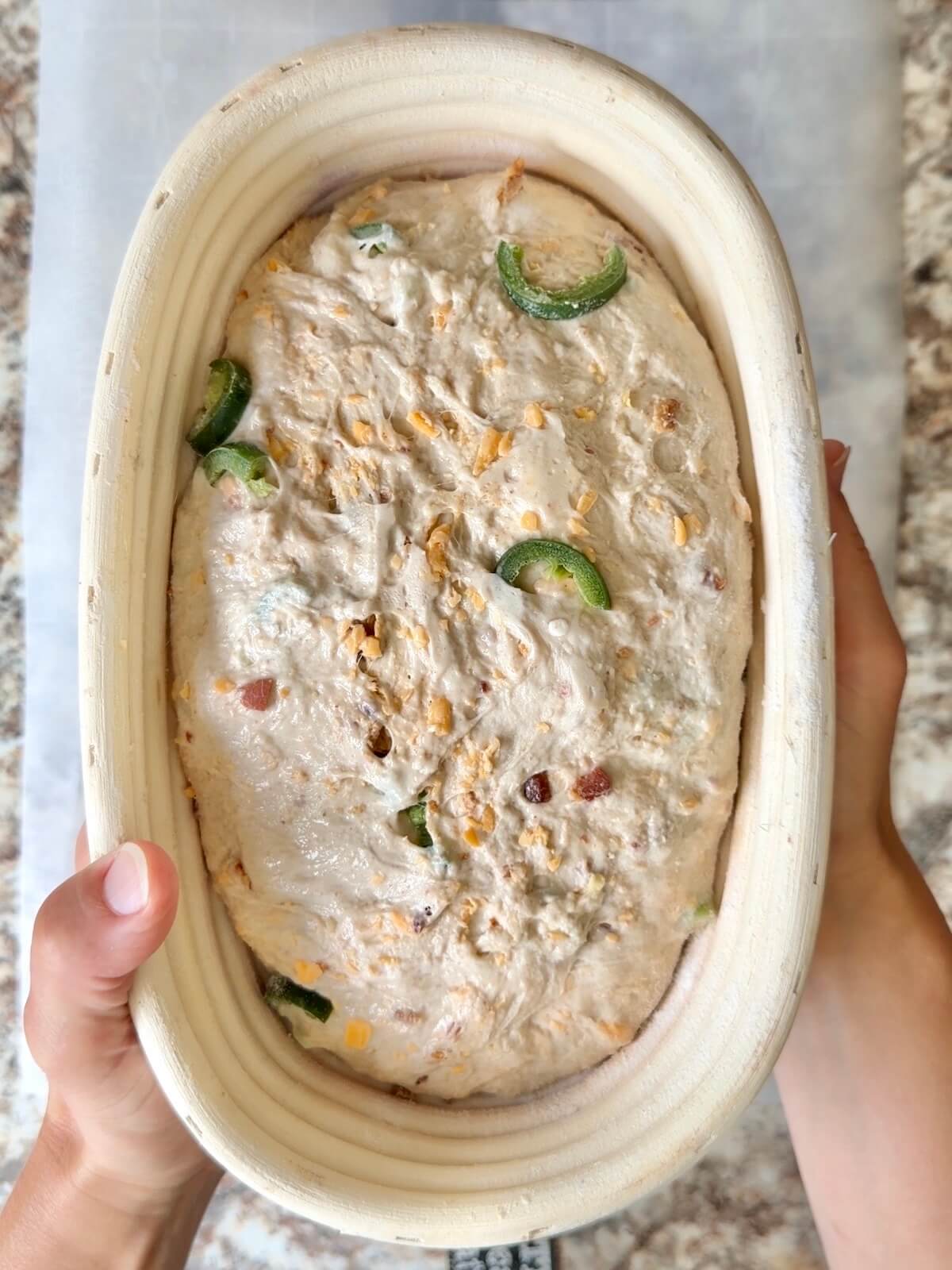 The dough in an oval proofing basket after cold proofing overnight.