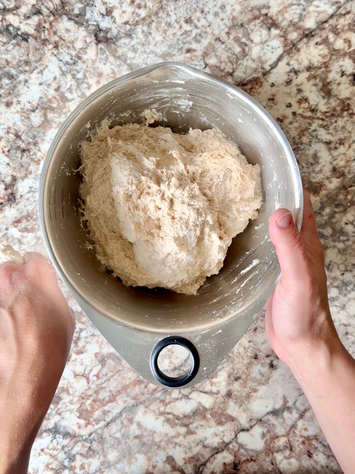 Sourdough bread dough mixed together in a bowl.