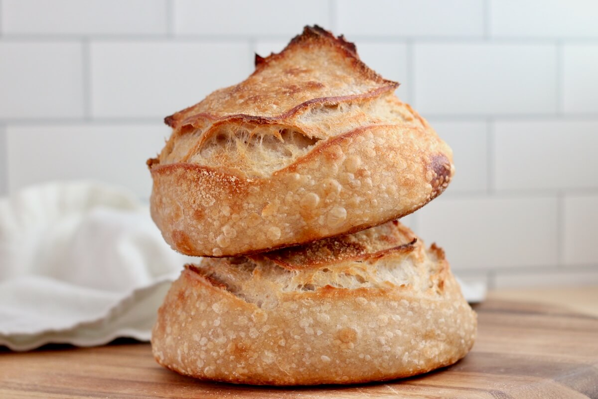 Two sourdough bread bowls stacked on top of one another.