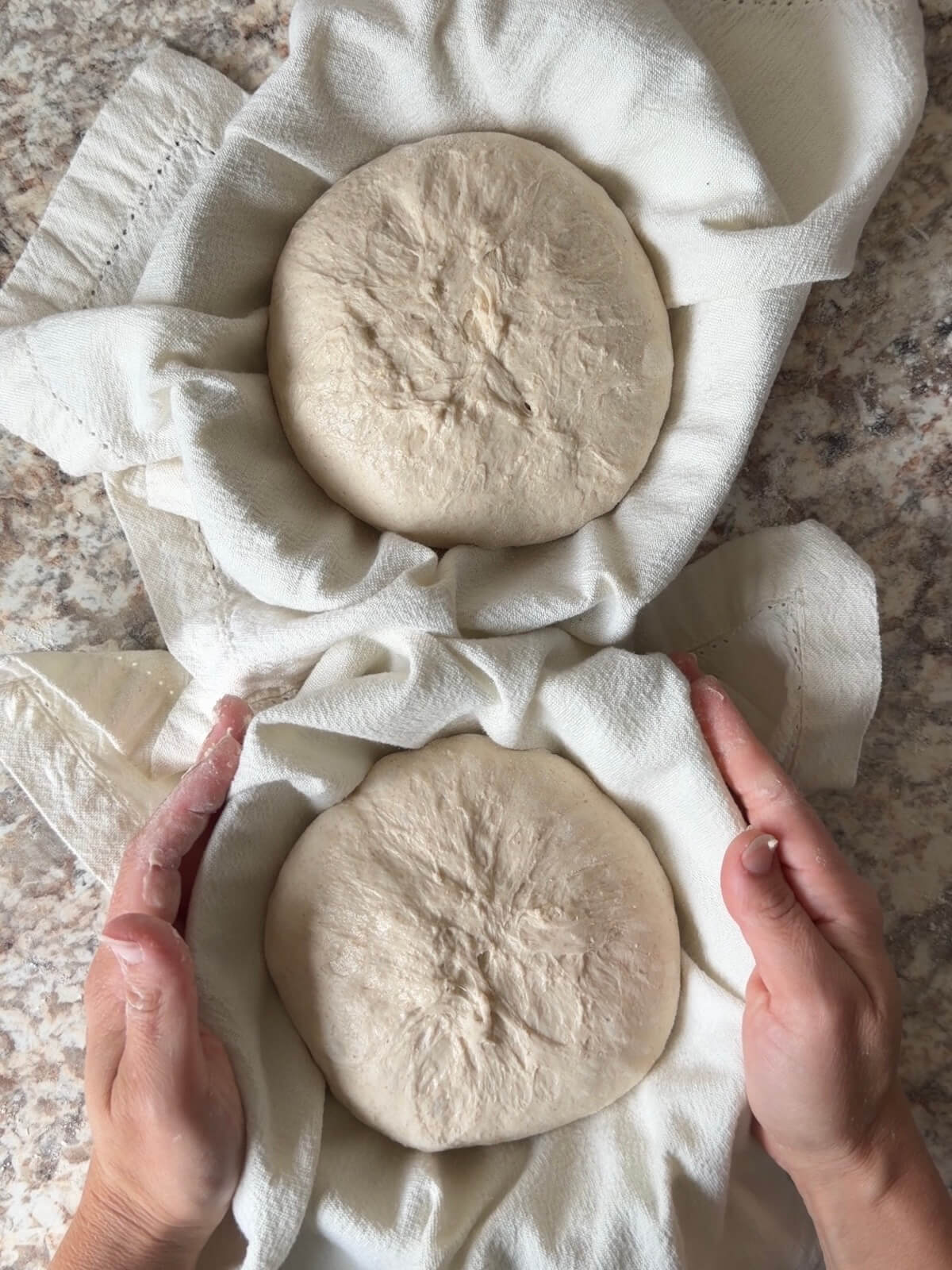 Two sourdough bread bowl doughs in cloth lined bowls before cold proofing overnight.