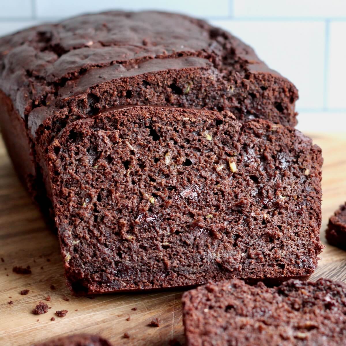 Sourdough chocolate zucchini bread cut into slices on a counter.
