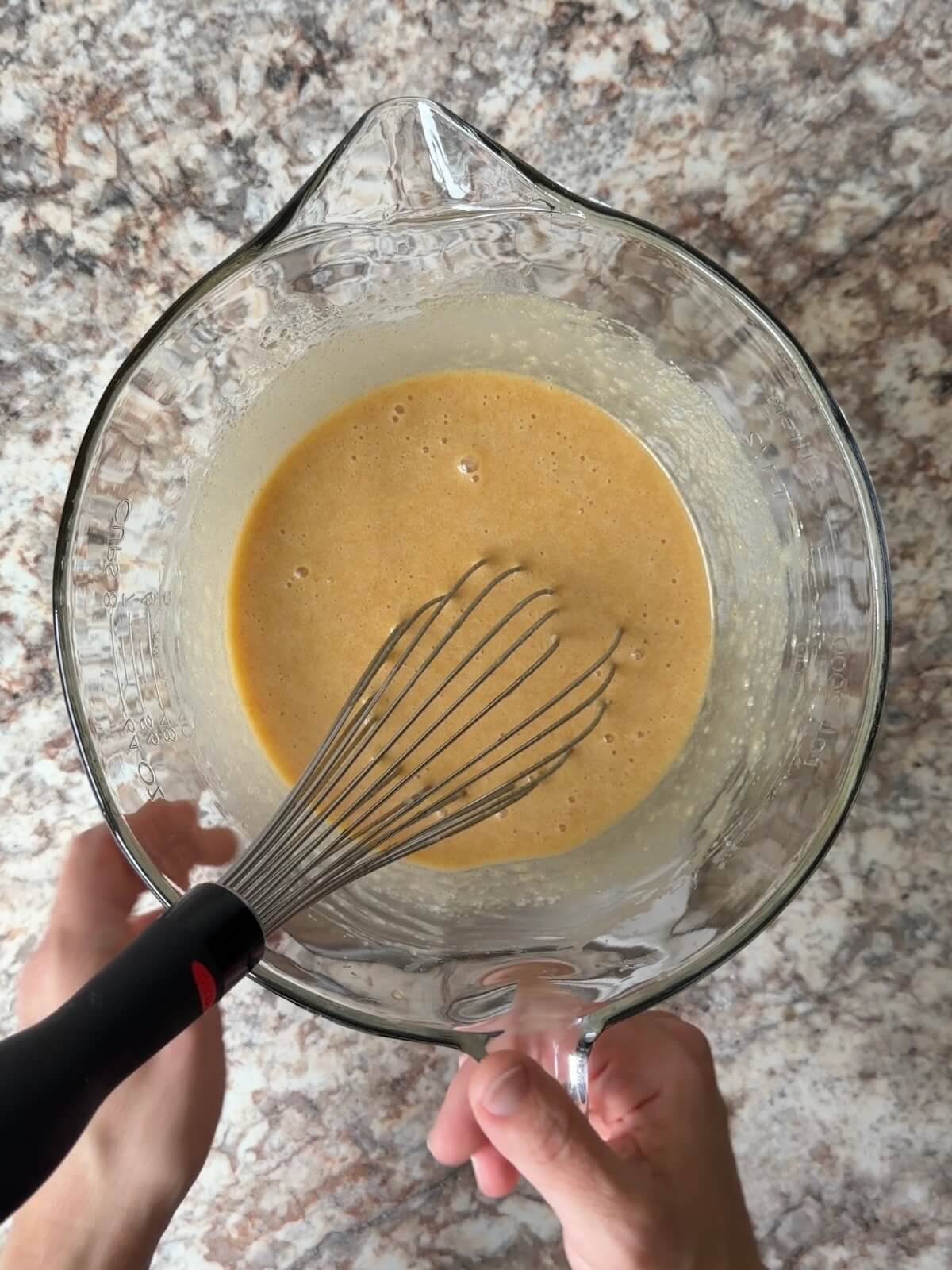 Sourdough discard and other wet ingredients whisked together in a bowl.