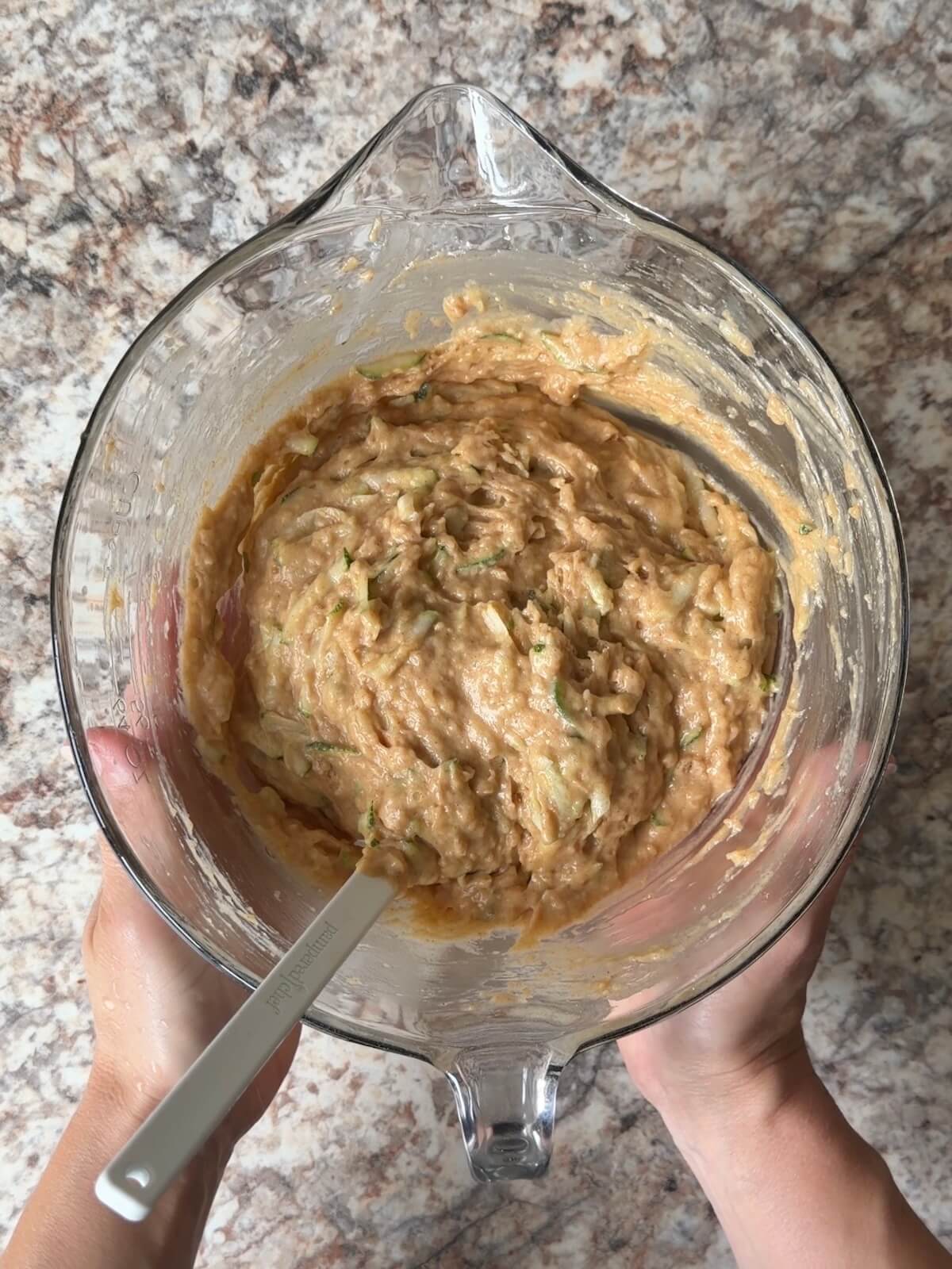 Sourdough zucchini muffin batter in a bowl.