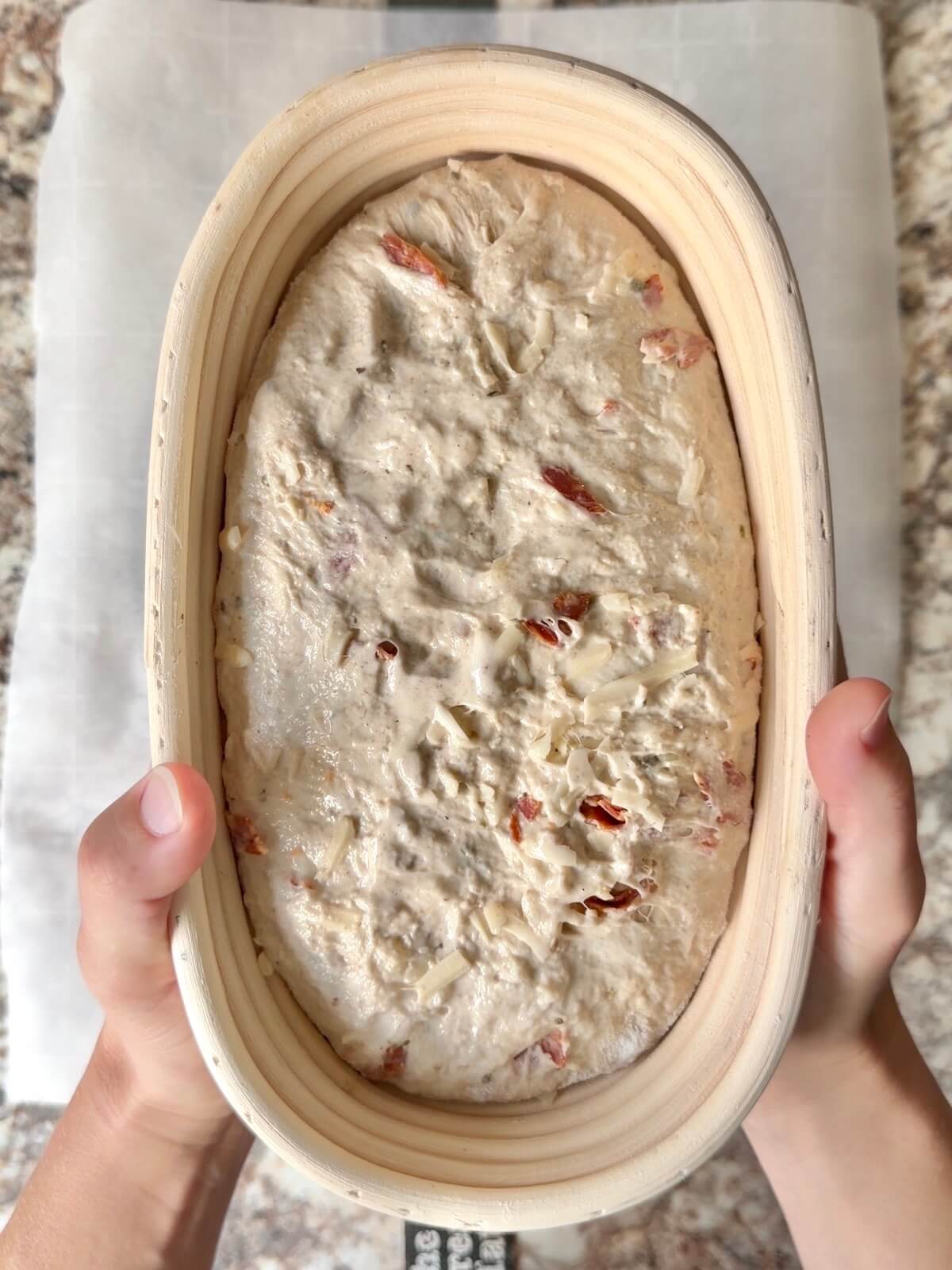 Pepperoni pizza sourdough bread in an oval proofing basket after cold proofing overnight.