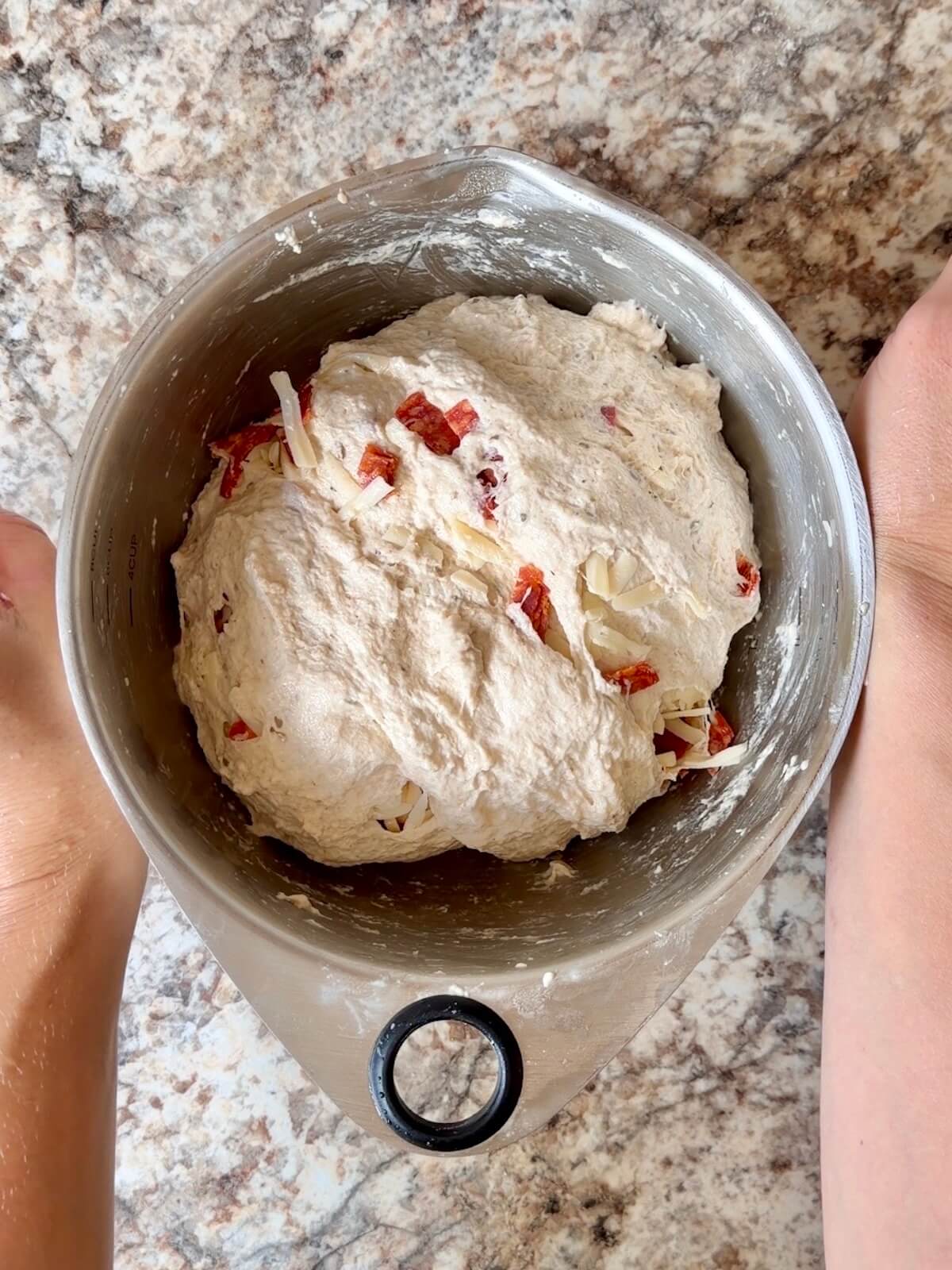 Pepperoni pizza sourdough bread dough in a mixing bowl.