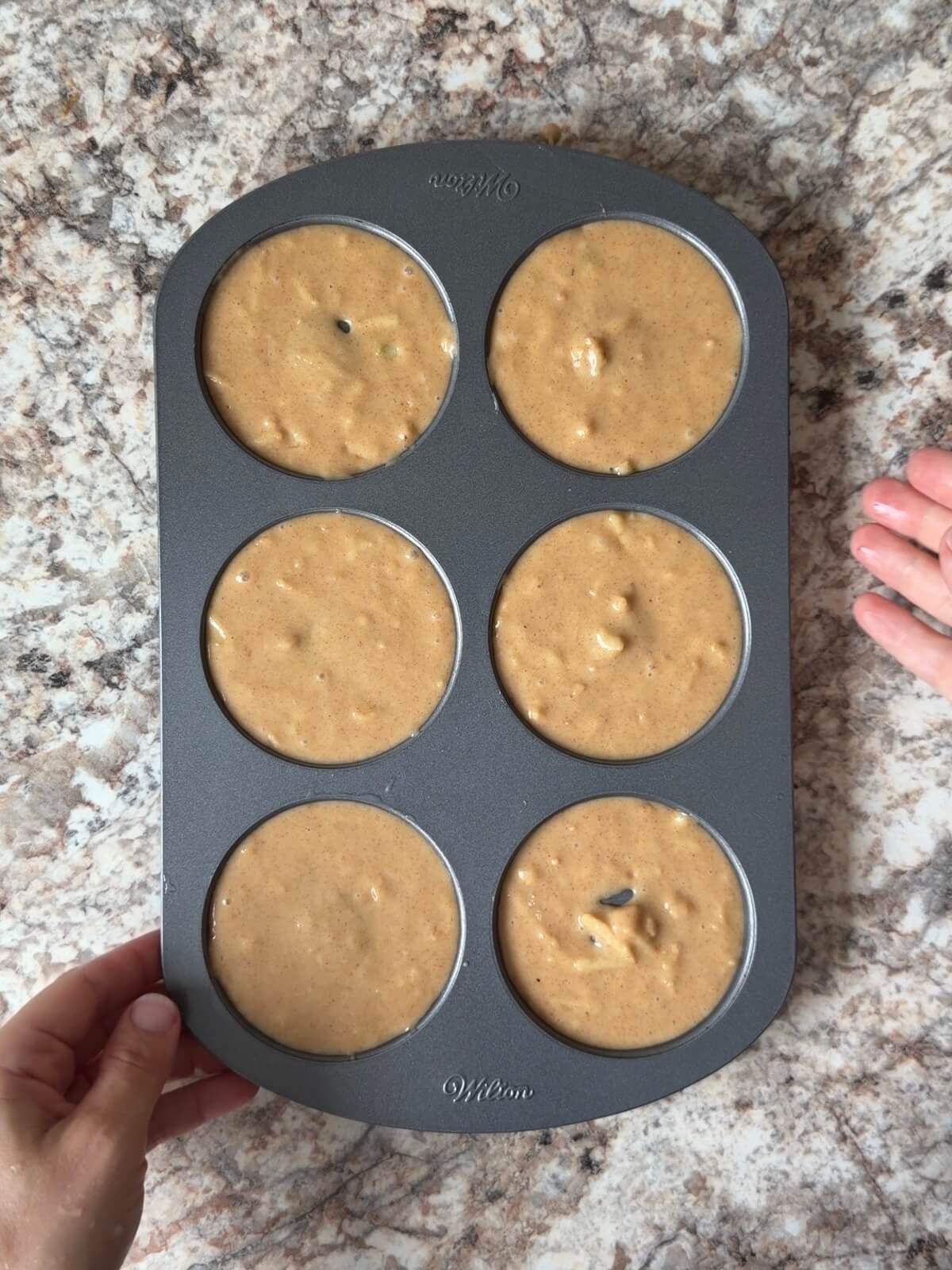 Sourdough discard apple cider donut batter in a donut pan.