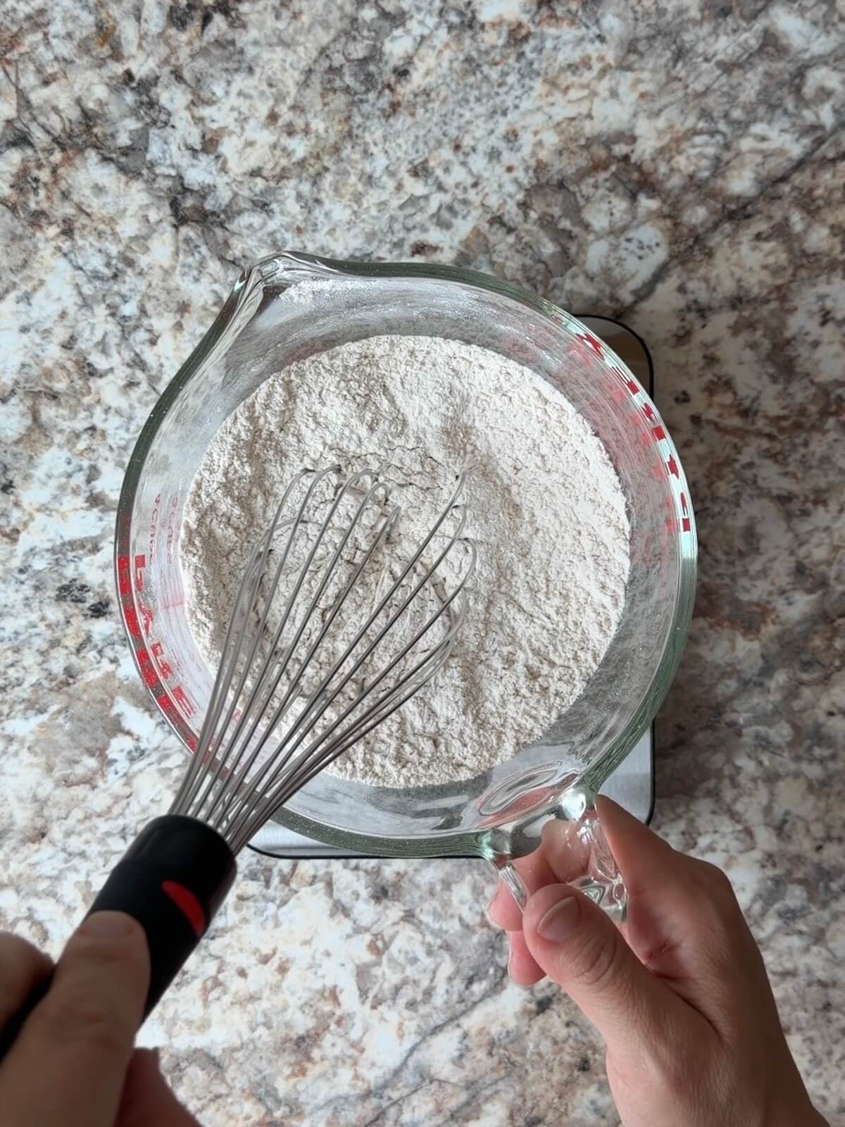 The dry ingredients whisked together in a glass bowl.