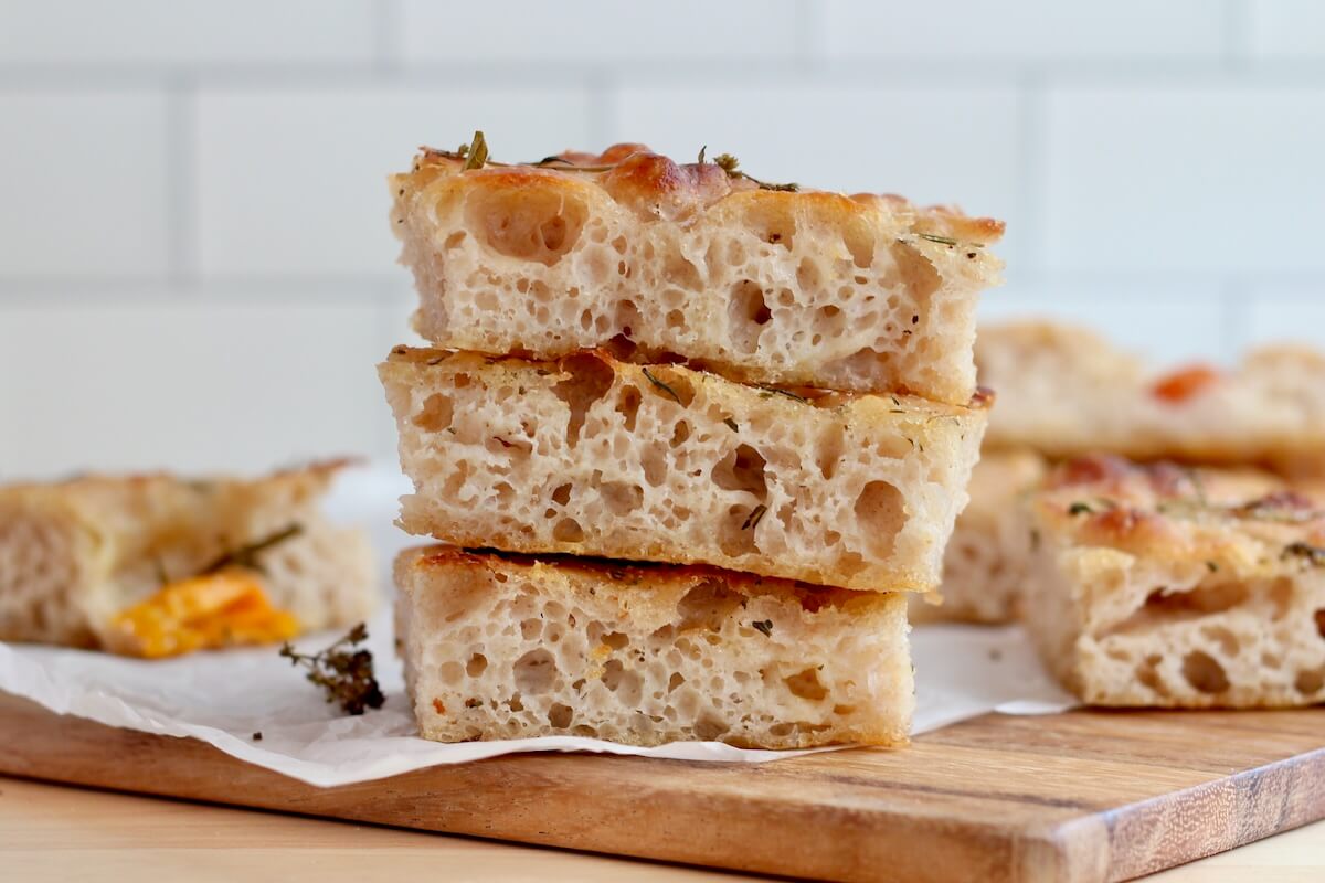 Three pieces of sourdough discard focaccia stacked on top of each other.