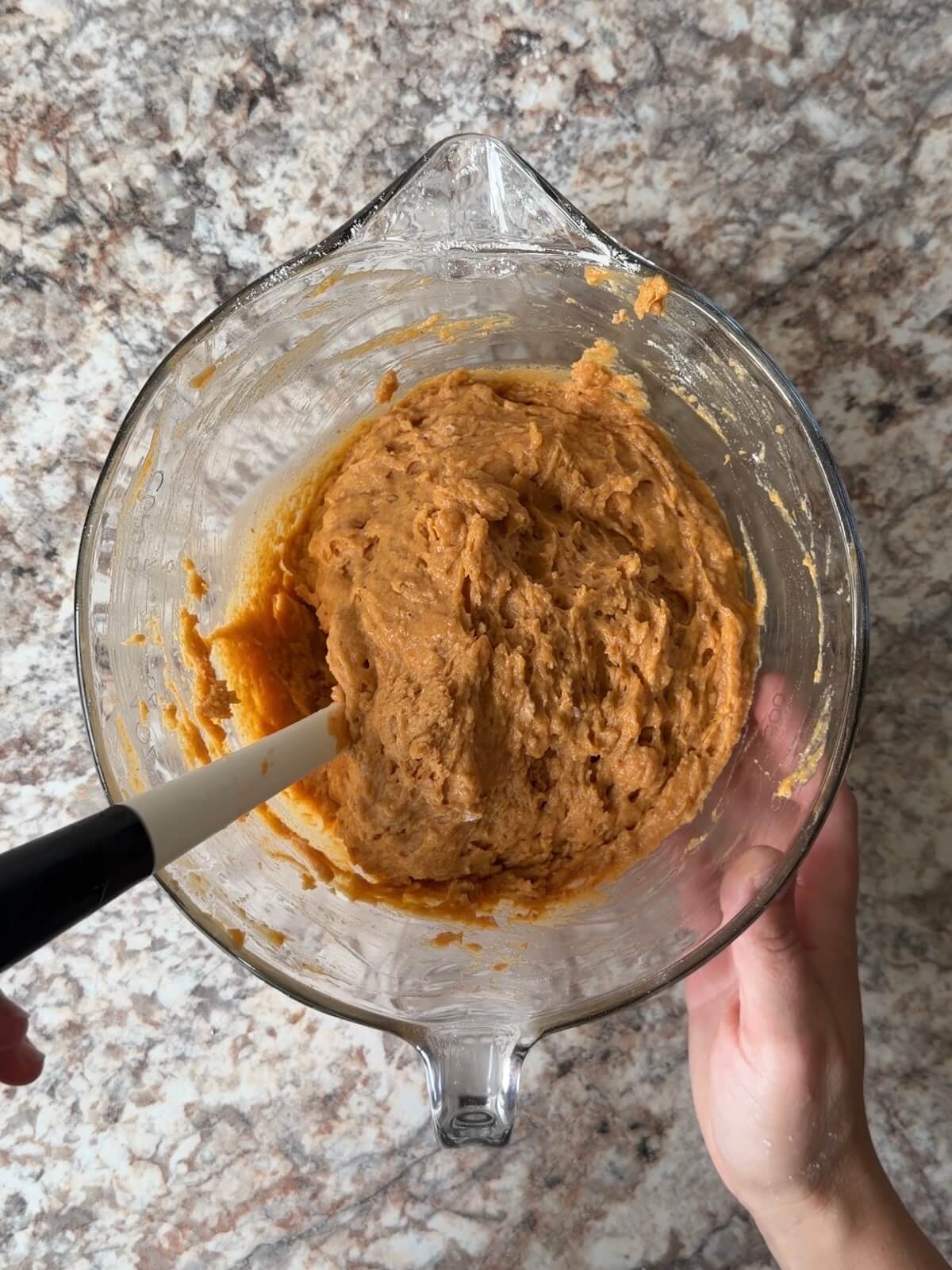 Sourdough pumpkin bread batter in a mixing bowl.